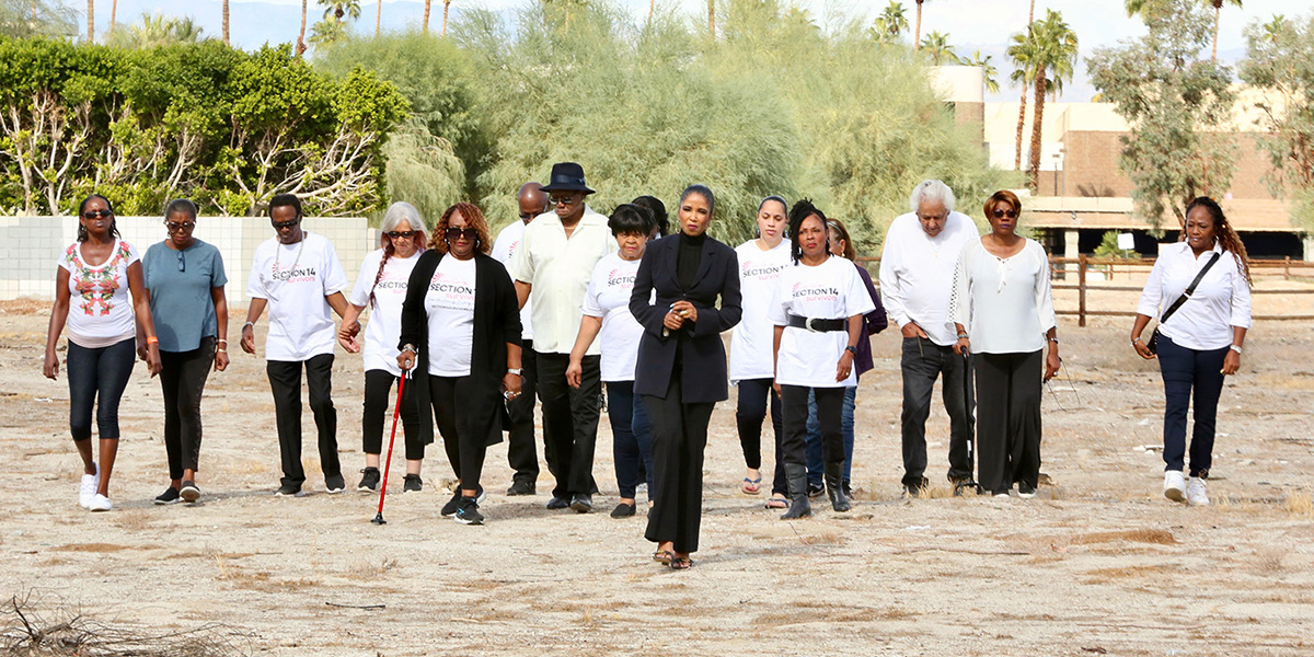 Section 14 Survivors walk on the land that once held their homes.