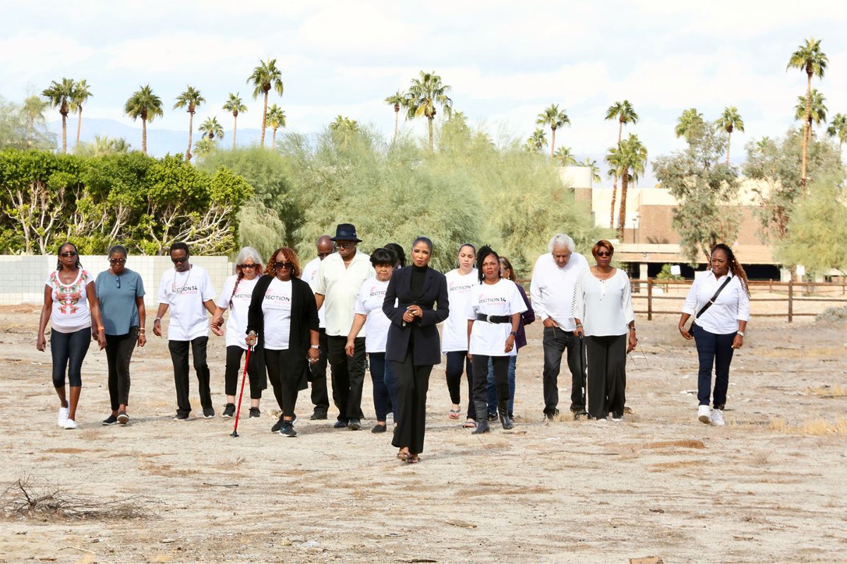 Section 14 Survivors walk with attorney Areva Martin